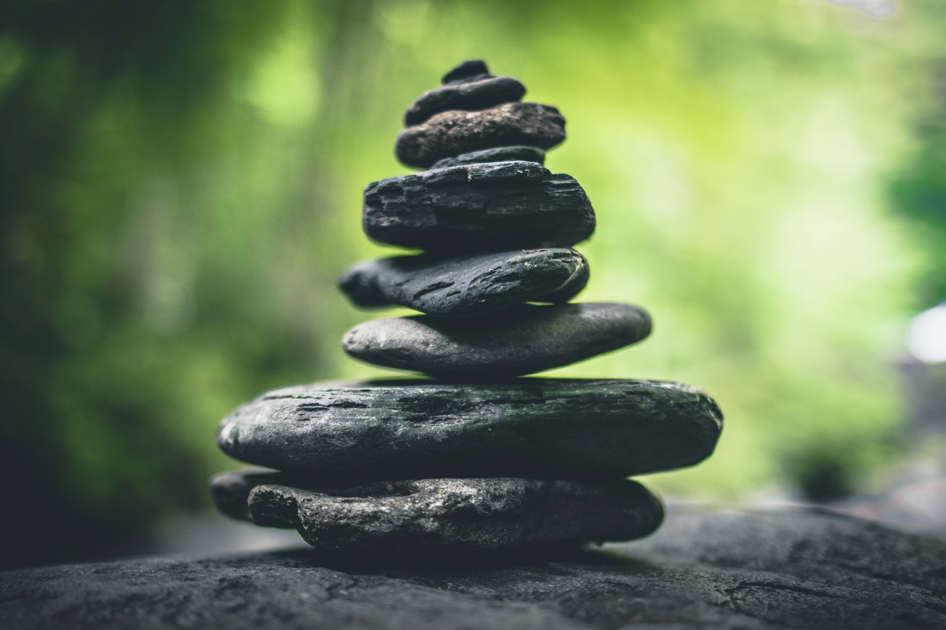 zen stones balancing with a green nature background